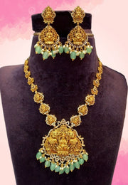 Traditional short haram with God laxmi devi motive and green colour stones and guttapusalu hangings